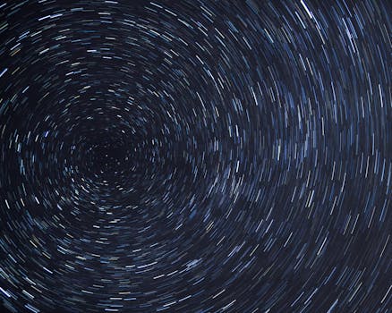 Dazzling star trails creating a spiral effect in the clear night sky.